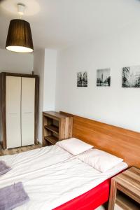Posteľ alebo postele v izbe v ubytovaní Apartament Centrum Harcerska
