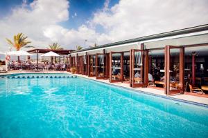 a large swimming pool next to a building at Portixol Hotel & Restaurant in Palma de Mallorca