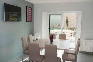 a dining room with a table and chairs at bayeux maison pierre 3 chambres in Cristot