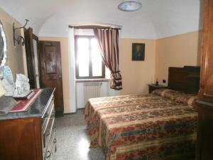 a hotel room with a bed and a window at B&B Rumanot in Dogliani