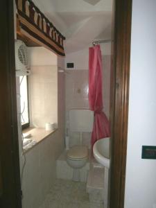 a small bathroom with a toilet and a sink at B&B Rumanot in Dogliani