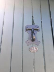 a door with a number sign on it at 16 Porto Santo Apartments in Porto Santo