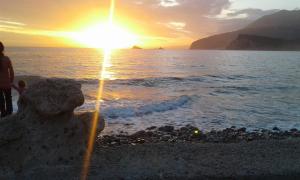 a sand sculpture on the beach at sunset at Buljarica Bay Apartments in Petrovac na Moru