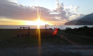 a sunset over the ocean with the sun shining at Buljarica Bay Apartments in Petrovac na Moru