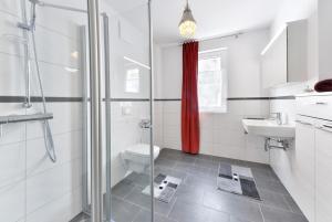 a bathroom with a shower and a toilet and a sink at Ferienwohnung Morgenrot in Juliusruh +8 photos