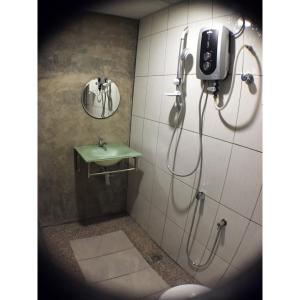 a bathroom with a toilet and a shower stall at Hotel Flora Plus in Cameron Highlands