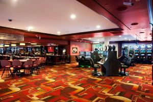 a casino with a bunch of slot machines in a room at Golden Gate Casino Hotel in Las Vegas