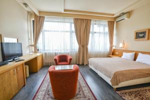 a hotel room with a bed and a television at Hotel Lirak in Tetovo