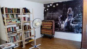 a room with two book shelves and a fan at le Galinier in Marseille