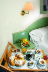 a tray of food on a table in a bed at Hotel Pensione Reale in Maiori