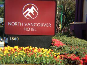 a sign for the north vancouver hotel with flowers at North Vancouver Hotel in North Vancouver +8 photos
