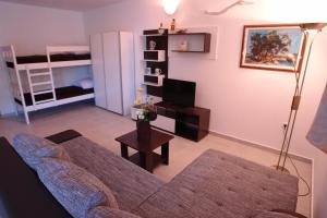 a living room with a couch and a table at Robinson Bella in Bogomolje +71 photos