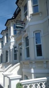 a white building with a sign in front of it at Seafield House in Brighton & Hove