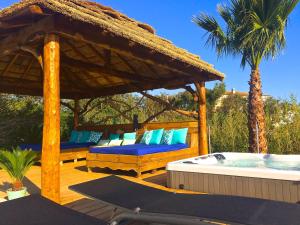 a deck with a gazebo and a hot tub at Villa Reve de Sud in Les Issambres