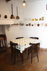 a table and chairs in a room with a table and shelves at CASA FAÑETE in Ruguilla