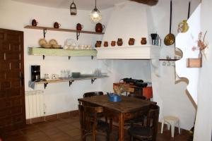 a room with a table and chairs and shelves at CASA FAÑETE in Ruguilla