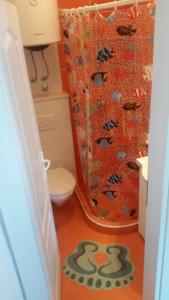 a bathroom with a toilet and a shower curtain at Apartments Miljevic in Herceg-Novi +13 photos