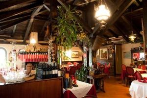 un restaurante con un bar con mesas y sillas en Hotel Makin, en Novigrad Istria