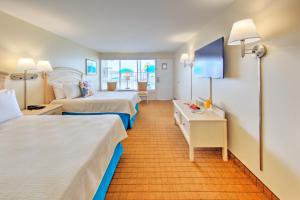 a hotel room with two beds and a desk at Dunes Court in Ocean City