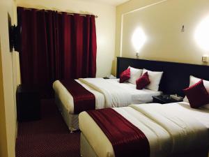 Postelja oz. postelje v sobi nastanitve Simba Hotel