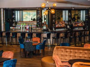 a bar with chairs and tables in a restaurant at The Riverside Park Hotel in Enniscorthy