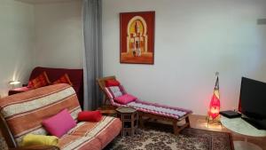 a living room with a couch and a chair at Chambre Avec Jardin Pierre Curie in Bry-sur-Marne