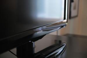 a black television sitting on top of a table at AmericInn by Wyndham Winona in Winona