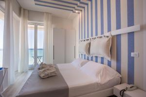 Postel nebo postele na pokoji v ubytování Hotel Nobel
