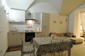 a kitchen and dining room with a table and chairs at Ortaccio relais & private SPA in Vasanello