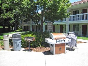 a sink and trash cans in front of a building at Extended Stay America Suites - San Jose - Mountain View in Mountain View