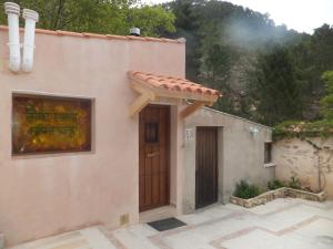 a house with a door and a mountain at La Limonera in Riópar