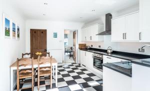 a kitchen with a black and white checkered floor at Lobster Cottage Lytham in Lytham St Annes