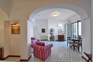 a living room with two chairs and a table at Hotel Belvedere in Conca dei Marini