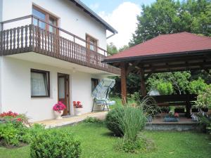 a house with a deck and a gazebo at Apartment and Rooms Ivancica in Seliste Dreznicko