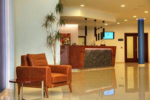 a waiting room with a chair and a table at Hotel Palace Medjugorje in Međugorje