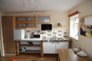 a small kitchen with a sink and a microwave at The Shepherd's Rest in Alnwick