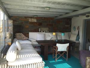 a living room with a couch and a table at Seaside Heaven in Otziás