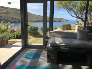 a living room with a couch in front of a door at Seaside Heaven in Otziás