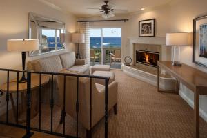 a living room with a couch and a fireplace at Pelican Inn & Suites in Cambria