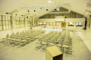 a large room with chairs and a podium in it at Africanos Country Estate in Addo +55 photos