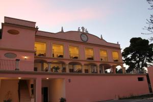 a large building with a clock on top of it at Residence Hotel Torresilvana in Vieste