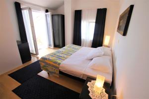 Postel nebo postele na pokoji v ubytování Apartments Macolic