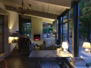 a living room with a table and a fireplace at "Le Vent d'Étoile" B&B and Guesthouses in Mormoiron