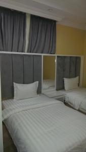 
A bed or beds in a room at Almakan Hotel 103
