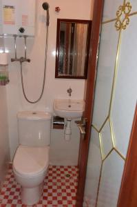 a bathroom with a toilet and a sink at Marrigold Hostel in Hong Kong