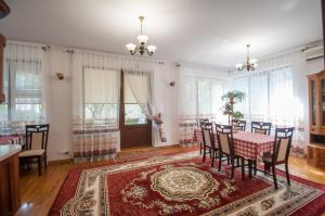 a dining room with a table and chairs at Magnificent Villa in Chişinău