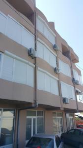 a large building with cars parked in front of it at VASILIJA, studio apartman in Budva