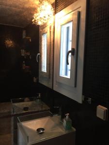 a bathroom with a sink and a mirror and a window at Seaside Heaven in Otziás