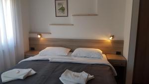 a bedroom with two beds with white towels on it at Villa Kristina in Rovinj
