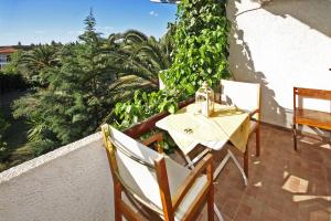 a patio with a table and chairs on a balcony at Villa Angela in Vourvourou